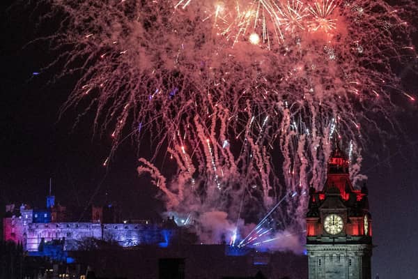Fireworks explode over Edinburgh Castle and the Balmoral Hotel during Edinburgh's Hogmanay street party. Picture: Jane Barlow/PA Wire