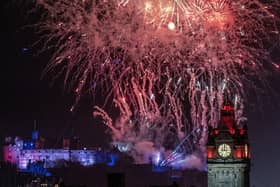 Fireworks explode over Edinburgh Castle and the Balmoral Hotel during Edinburgh's Hogmanay street party. Picture: Jane Barlow/PA Wire