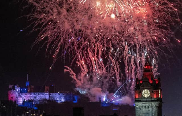 Fireworks explode over Edinburgh Castle and the Balmoral Hotel during Edinburgh's Hogmanay street party. Picture: Jane Barlow/PA Wire