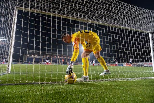 Falkirk's Peter Morrison picks the ball out of the net during a Betfred Cup match between Falkirk and Rangers.