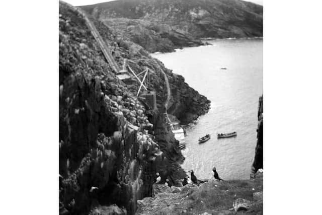 The Flannan Isles and the winch that was used to pull building materials onto the island as the lighthouse was being constructed. PIC: Courtesy of Urras an Taighe Mhòir.