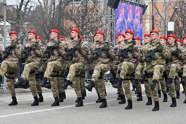 Bosnian Serb police officers take part in a parade marking the Day of Republic Srpska, in Banja Luka, on Sunday, watched by the Russian ambassador to Bosnia, Igor Kalabuhov (Picture: Elvis Barukcic/AFP via Getty Images)