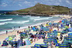 Holidaymakers enjoy the sunny weather at Porthmeor Beach in St Ives, Cornwall (Picture: Matt Cardy/Getty Images)
