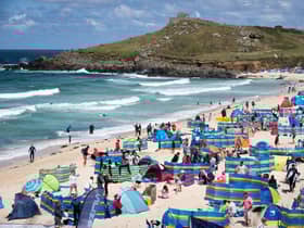 Holidaymakers enjoy the sunny weather at Porthmeor Beach in St Ives, Cornwall (Picture: Matt Cardy/Getty Images)