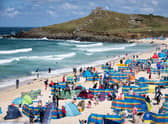 Holidaymakers enjoy the sunny weather at Porthmeor Beach in St Ives, Cornwall (Picture: Matt Cardy/Getty Images)