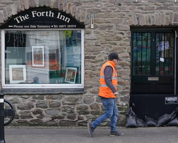 Sand bags sit in a doorway in Aberfoyle in Perthshire in preparation for Storm Babet. Picture: Andrew Milligan/PA Wire