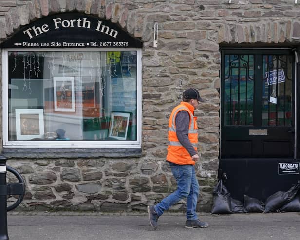 Sand bags sit in a doorway in Aberfoyle in Perthshire in preparation for Storm Babet. Picture: Andrew Milligan/PA Wire