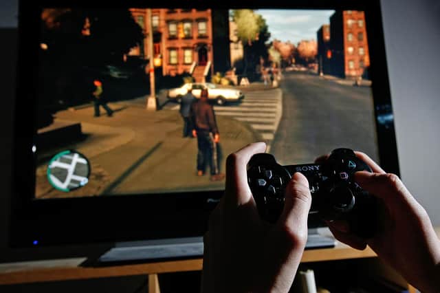 A young man plays Grand Theft Auto IV on a Playstation 3 (Picture: Cate Gillon/Getty Images)