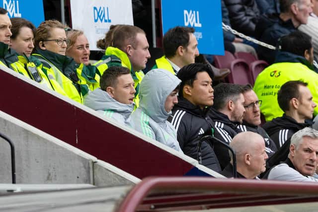 Celtic's Callum McGregor watches on injured from the Tynecastle stand.