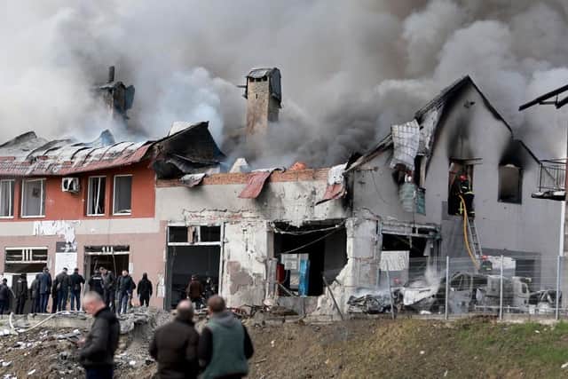Firefighters battle a blaze after a civilian building was hit by a Russian missile in Lviv, Ukraine.