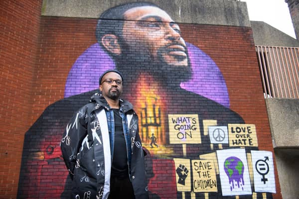 Artist Dreph with a 16ft mural he created in Brixton to celebrate the 50th anniversary of Marvin Gaye's album What's Going On (Picture: Matt Crossick/PA)