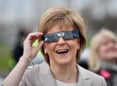 Nicola Sturgeon uses protective glasses to look at a partial solar eclipse (Picture: Jeff J Mitchell/Getty Images)