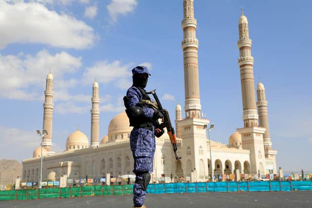 A Huthi fighter stands guard in front of Sanaa's Al-Saleh Grand Mosque, which the Iran-backed movement renamed the People's Mosque, during a protest in solidarity with the Palestinian people in the Huthi-controlled Yemeni capital Sanaa. Picture: Mohammed Huwais/AFP via Getty Images