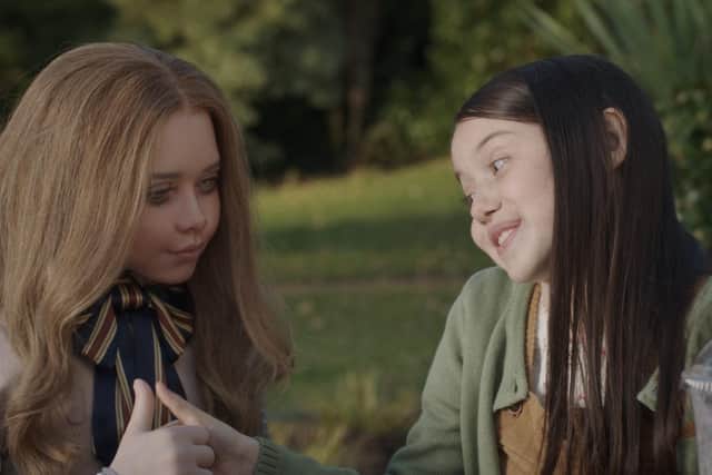 From left, M3GAN and Cady (Violet McGraw) in M3GAN