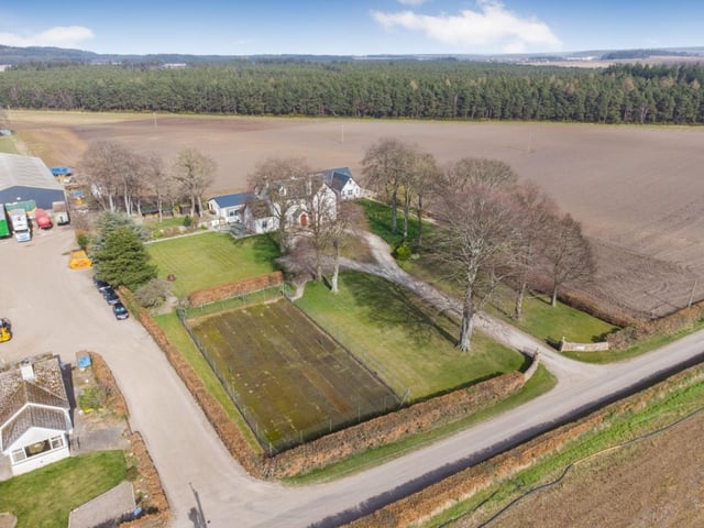 Aerial view of property and grounds.