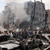 Palestinians search for survivors after an Israeli airstrike on buildings in the refugee camp of Jabalia in the Gaza Strip (Photo by MOHAMMED ABED/AFP via Getty Images)