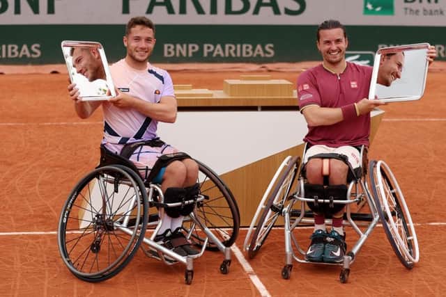 Alfie Hewett of Great Britain (L) and partner Gordon Reid of Great Britain celebrate after winning the Men's Wheelchair Doubles Final of The 2022 French Open at Roland Garros. (Photo by Clive Brunskill/Getty Images)