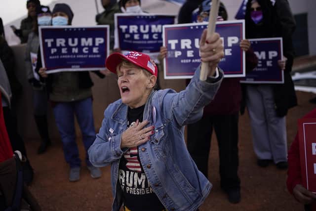 A Trump supporter holds her hand over her heart during a protest about the election outside of the Clark County Election Department in Las Vegas. (Picture: John Locher/AP)