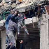 Locals in Jandaris (Syria) rescue an injured girl from the debris of a building destroyed by a major earthquake.