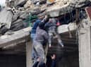 Locals in Jandaris (Syria) rescue an injured girl from the debris of a building destroyed by a major earthquake.