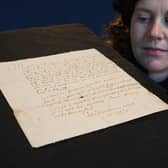 Cathy Marsden of Lyon & Turnbull with a letter featuring the handwriting of Mary Queen of Scots that is being sold by the auction house next month. Photo: Stewart Attwood/Lyon & Turnbull/PA Wire
