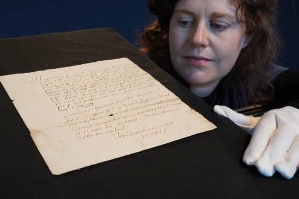 Cathy Marsden of Lyon & Turnbull with a letter featuring the handwriting of Mary Queen of Scots that is being sold by the auction house next month. Photo: Stewart Attwood/Lyon & Turnbull/PA Wire