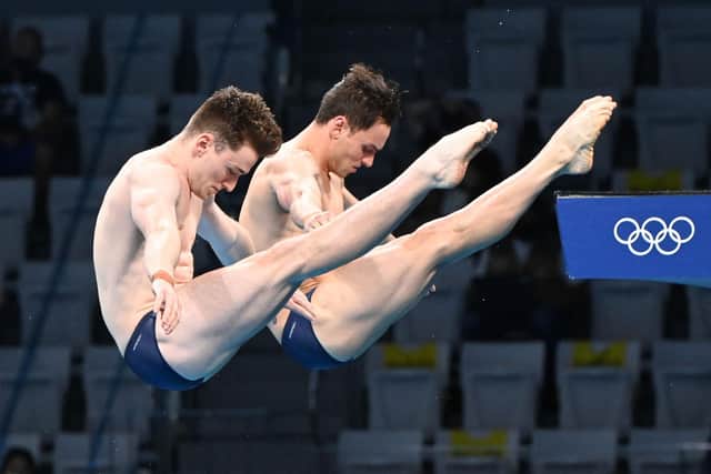 Why do Olympic divers wear tape and shower? Why are some scores crossed out in diving at the Tokyo Olympic Games 2020? (Image by Attila Kisbenedek/AFP via Getty Images)