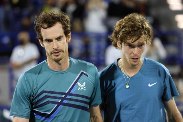 Andy Murray and Andrey Rublev walk together during the final match of the Mubadala World Tennis Championship in Abu Dhabi (Photo by GIUSEPPE CACACE/AFP via Getty Images)