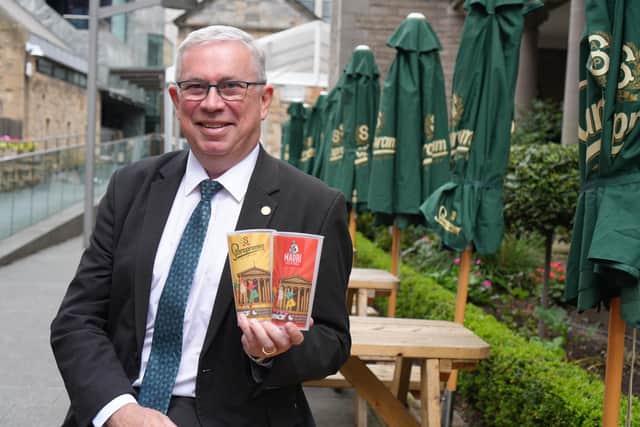 Scott Mitchell, Managing Director at Surgeon's Quarter, with examples of the venue's reusable souvenir cups