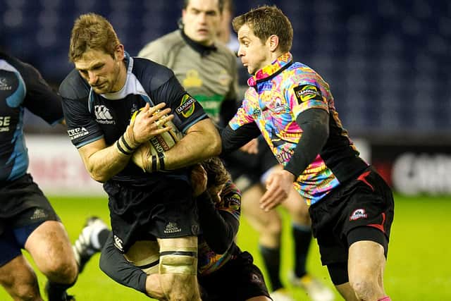 Glasgow's John Barclay is pursued by Edinburgh's Chris Paterson during an 1872 Cup clash in January 2010.