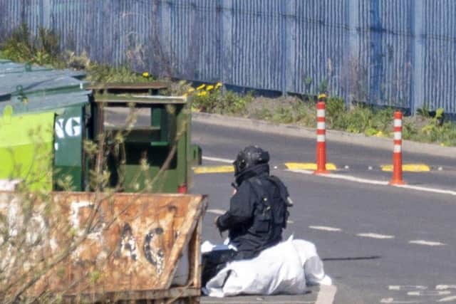 A member of the bomb disposal team inspects the object at Seafield recycling centre. Pic: Andy O'Brien