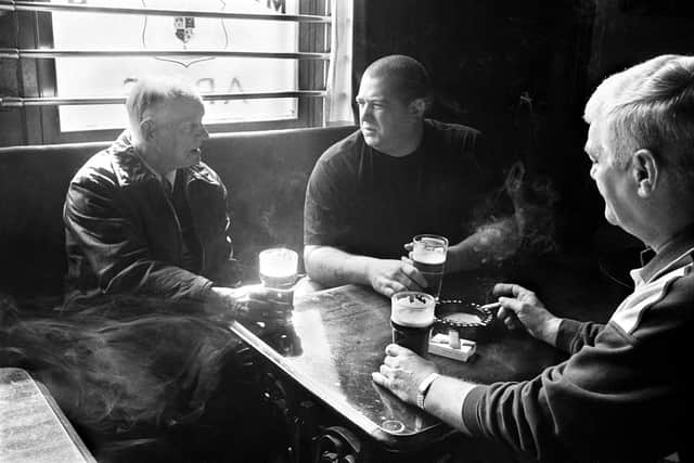Longannet Colliery, three generations of miners. George Lang (centre), grandfather Jock Land (left) and father Bert Lang (right) have been miners all their lives. They are pictured having a beer in the Mansfield Arms, Sauchie, Scotland, April 2001.  © Jeremy Sutton-Hibbert/ Courtesy of University of St Andrews.