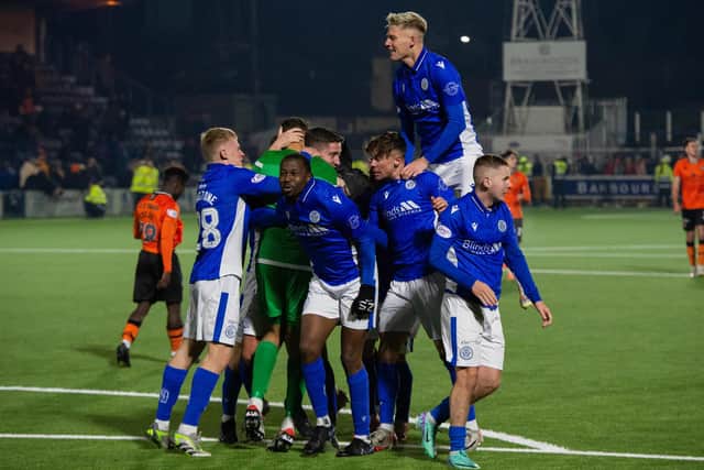 Queen of the South players celebrate beating Dundee United on penalties.