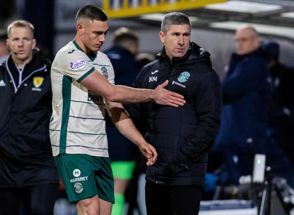 Hibs manager Nick Montgomery speaks to Lewis Miller after his sending off against Dundee.