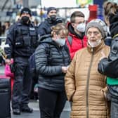 Volunteers with green jackets provide assistance to Ukrainians fleeing the war in Ukraine as they disembark from a train coming from Warsaw at Hauptbahnhof main railway station in Berlin, Germany, in March.