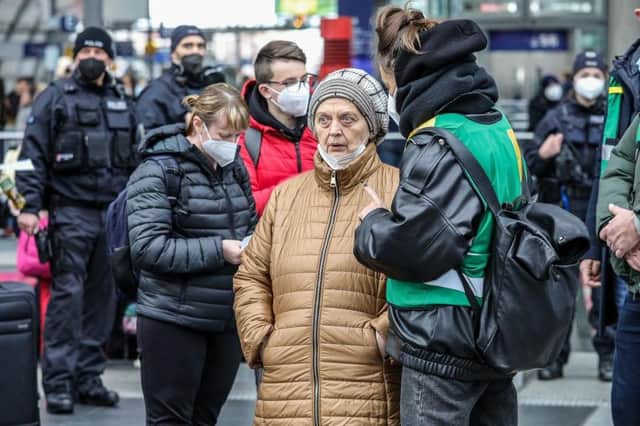 Volunteers with green jackets provide assistance to Ukrainians fleeing the war in Ukraine as they disembark from a train coming from Warsaw at Hauptbahnhof main railway station in Berlin, Germany, in March.