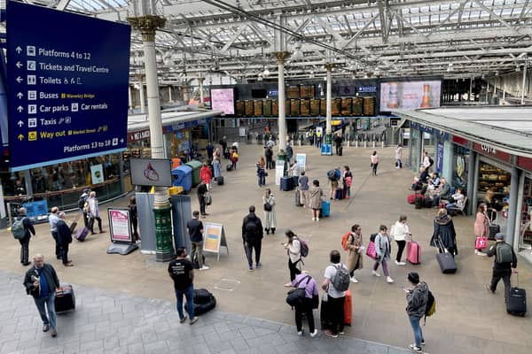 Commuters and travellers at Edinburgh's Waverley Station.