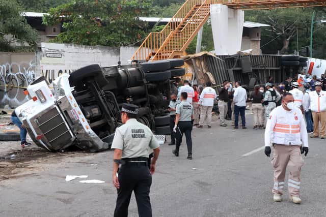 Mexican national guard officers work in the area where a trucked rolled over after a traffic accident that killed people emigrating from Central America on December 9, 2021 in Tuxtla Gutierrez, Mexico. (Photo by Alfredo Pacheco/Getty Images)