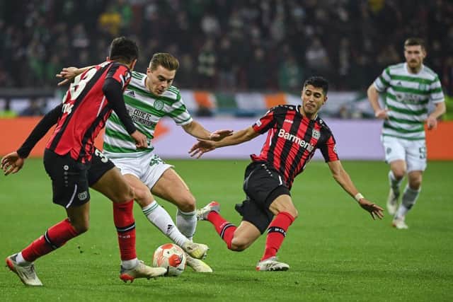 Leverkusen's Ecuadorian defender Piero Hincapie (L) and Celtic's Scottish midfielder James Forrest vie for the ball (Photo by INA FASSBENDER/AFP via Getty Images)