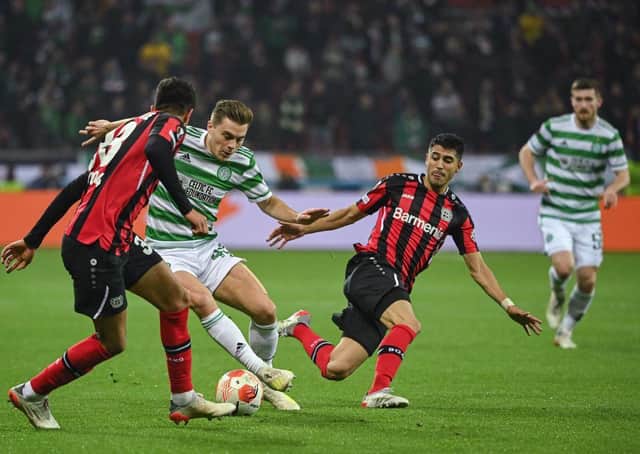 Leverkusen's Ecuadorian defender Piero Hincapie (L) and Celtic's Scottish midfielder James Forrest vie for the ball (Photo by INA FASSBENDER/AFP via Getty Images)