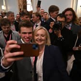 Former Prime Minister Liz Truss poses for a selfie at the 'Great British Growth Rally' during the Conservative party conference in October (Picture: Justin Tallis/AFP via Getty Images)