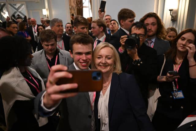 Former Prime Minister Liz Truss poses for a selfie at the 'Great British Growth Rally' during the Conservative party conference in October (Picture: Justin Tallis/AFP via Getty Images)