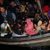 Rohingya refugees are rescued from a wooden boat near the Aceh province of Indonesia a year ago.