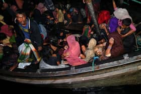 Rohingya refugees are rescued from a wooden boat near the Aceh province of Indonesia a year ago.