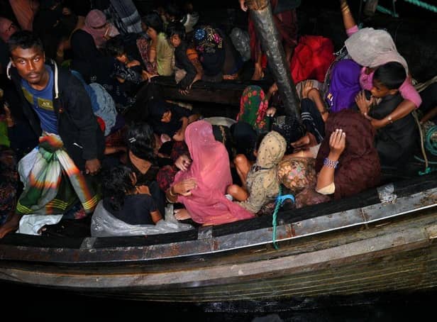 Rohingya refugees are rescued from a wooden boat near the Aceh province of Indonesia a year ago.