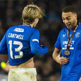 Rangers' Todd Cantwell and Cyriel Dessers celebrate with their medals.