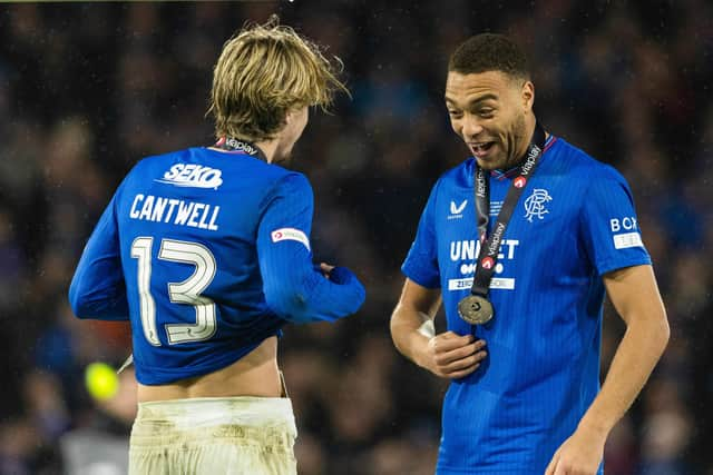 Rangers' Todd Cantwell and Cyriel Dessers celebrate with their medals.