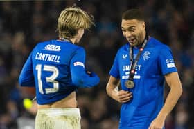 Rangers' Todd Cantwell and Cyriel Dessers celebrate with their medals.