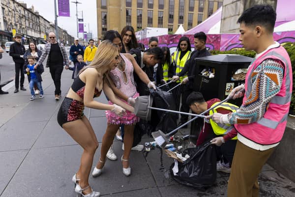 Cast and crew from The Ladyboys of Bangkok have been clearing rubbish up outside their venue on Lothian Road. Picture: Duncan McGlynn