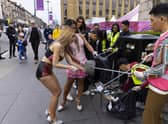 Cast and crew from The Ladyboys of Bangkok have been clearing rubbish up outside their venue on Lothian Road. Picture: Duncan McGlynn